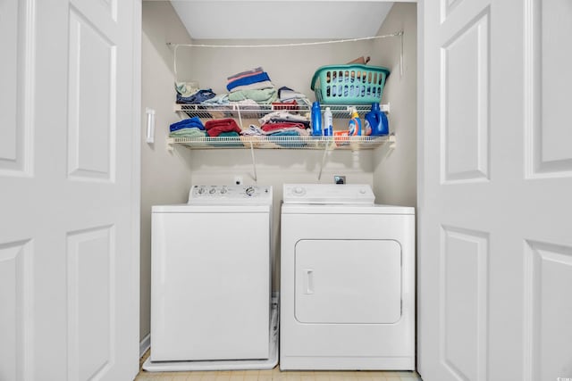 washroom featuring light tile patterned floors and washing machine and clothes dryer