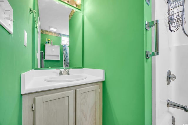 bathroom featuring vanity and  shower combination