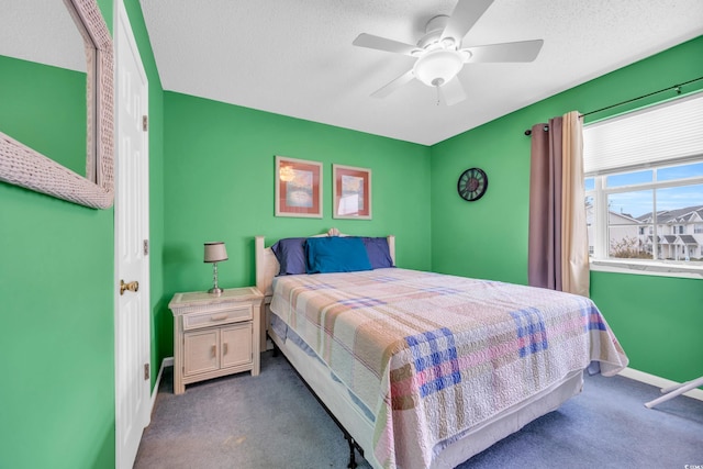 carpeted bedroom with a textured ceiling and ceiling fan