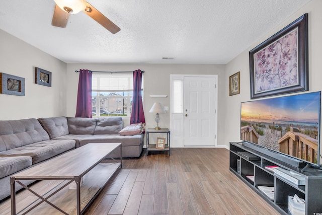 living room featuring hardwood / wood-style floors and a textured ceiling