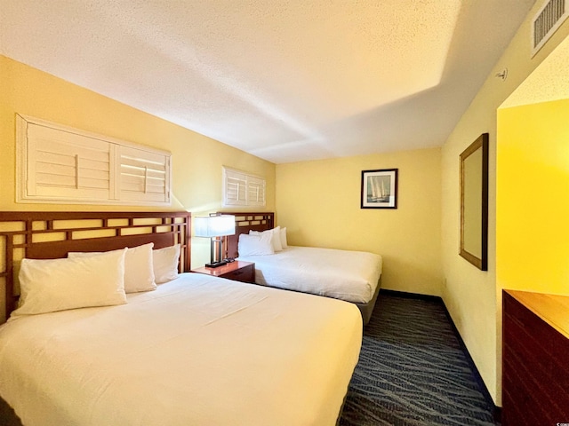 carpeted bedroom with a textured ceiling