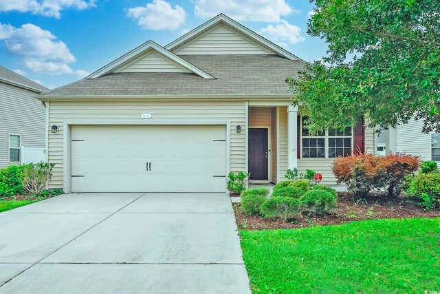 view of front of property with a garage and a front yard