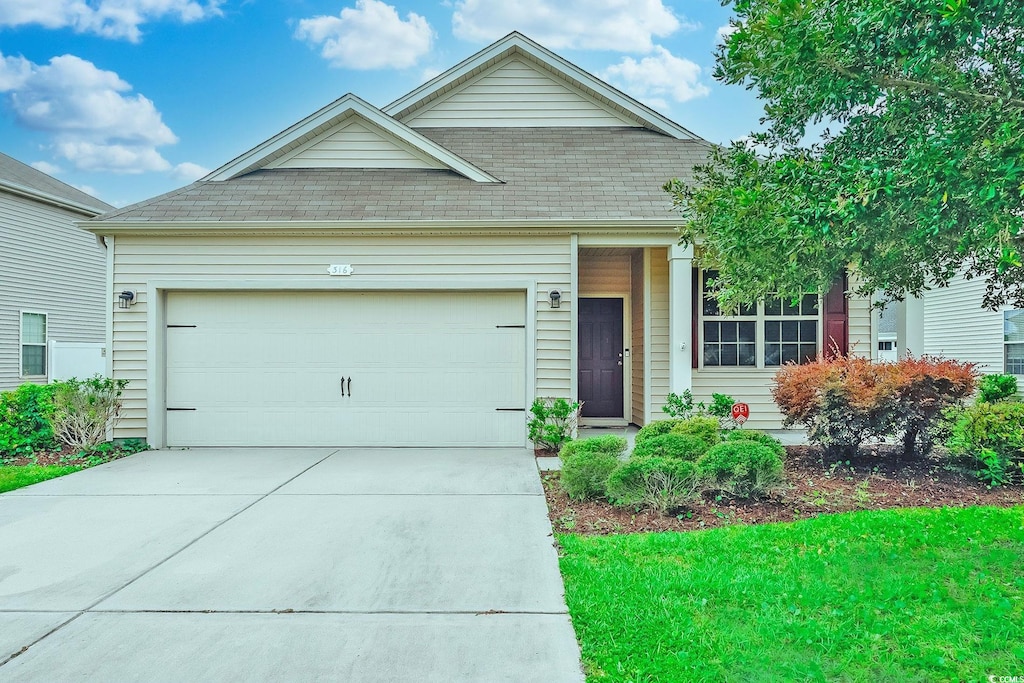 view of front of property with a garage and a front yard