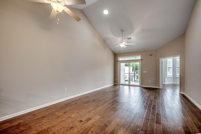 spare room featuring dark hardwood / wood-style flooring, vaulted ceiling, and ceiling fan