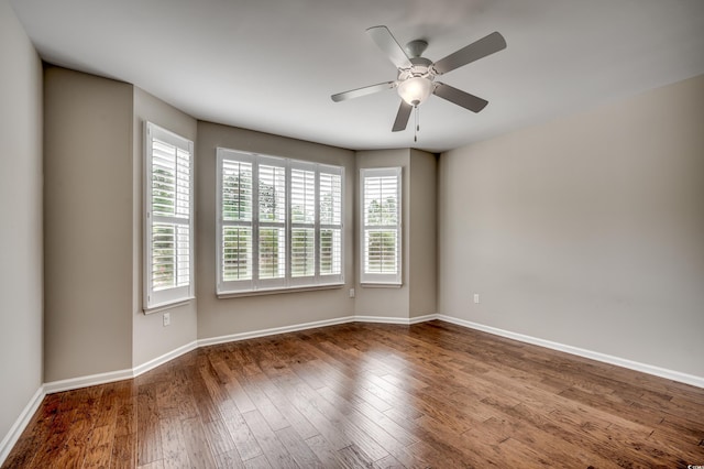 spare room featuring hardwood / wood-style flooring, ceiling fan, and a healthy amount of sunlight