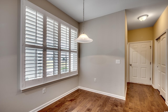 unfurnished dining area with hardwood / wood-style floors and a wealth of natural light