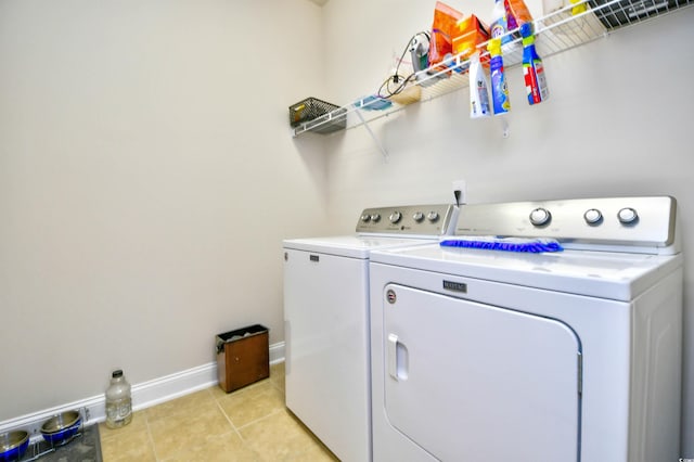 washroom with separate washer and dryer and light tile patterned flooring