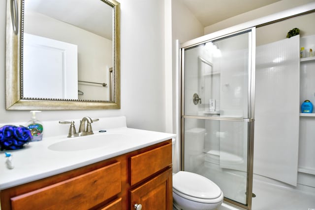 bathroom with vanity, toilet, and an enclosed shower