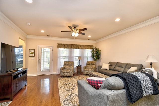 living room with crown molding, ceiling fan, and wood-type flooring