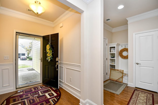 foyer featuring dark hardwood / wood-style flooring and ornamental molding