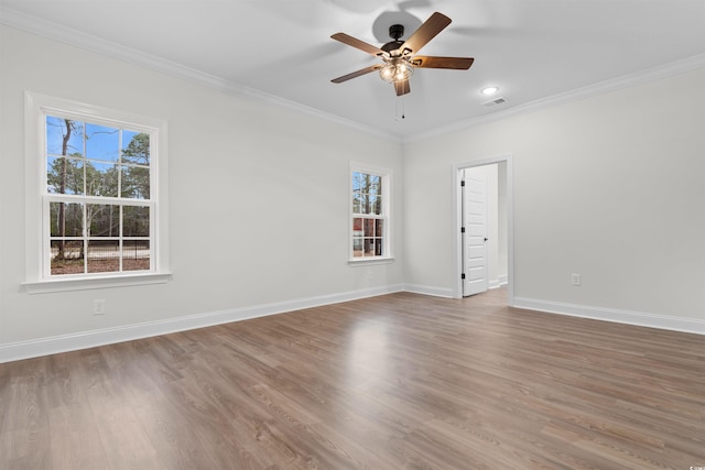 empty room featuring ceiling fan, ornamental molding, and hardwood / wood-style floors