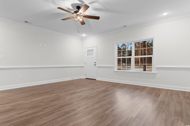 unfurnished room with hardwood / wood-style floors, ornamental molding, and ceiling fan