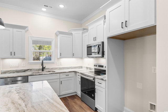 kitchen featuring sink, appliances with stainless steel finishes, and white cabinets