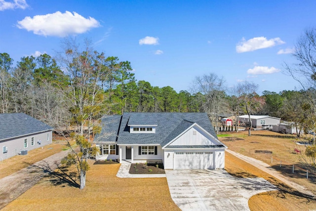 view of front of home featuring a front yard, a garage, and a porch