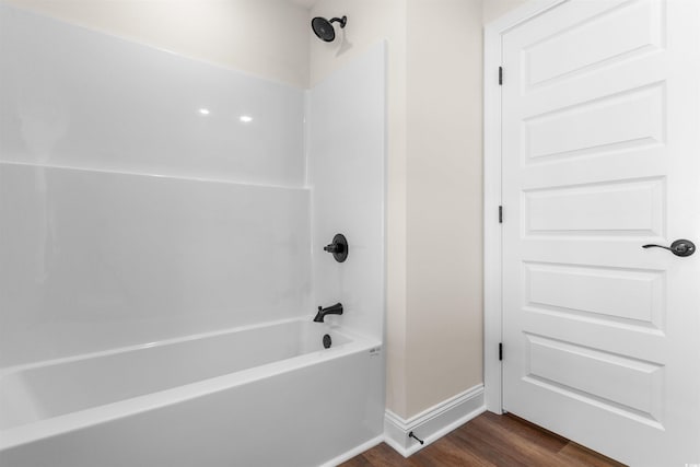 bathroom with hardwood / wood-style flooring and shower / bathing tub combination