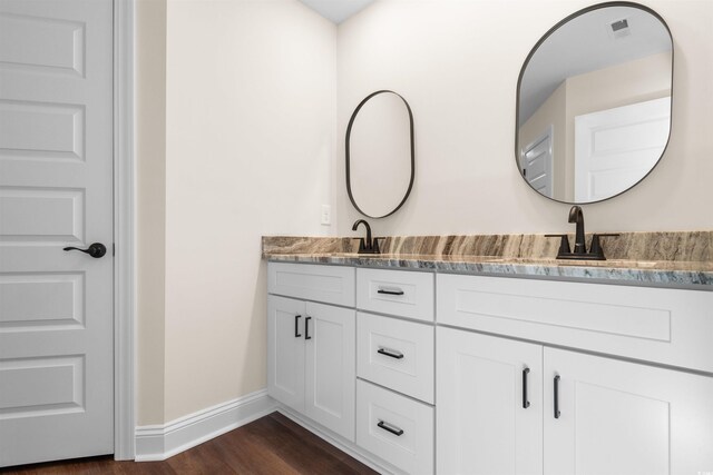 bathroom featuring vanity, hardwood / wood-style floors, and walk in shower