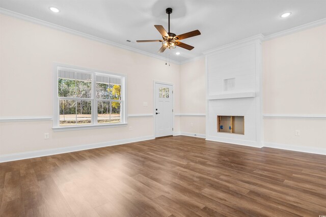 unfurnished living room with wood-type flooring, ornamental molding, and a fireplace