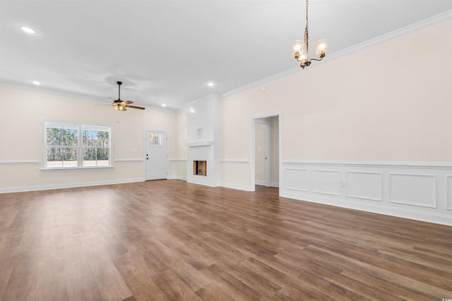 unfurnished living room with ornamental molding, hardwood / wood-style floors, and ceiling fan with notable chandelier