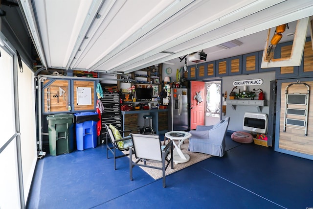 2256 Heritage Loop Unit 2256, Myrtle Beach, SC 29577 - garage with a workshop area, a garage door opener, stainless steel refrigerator with ice dispenser, and heating unit