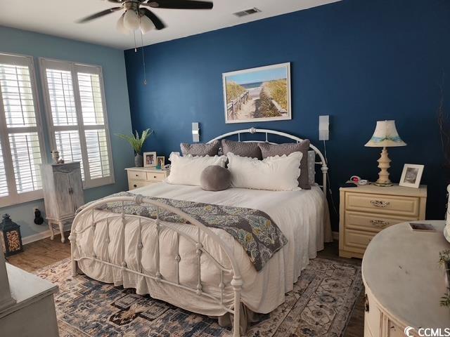 2256 Heritage Loop Unit 2256, Myrtle Beach, SC 29577 - bedroom with wood finished floors, visible vents, a ceiling fan, and baseboards