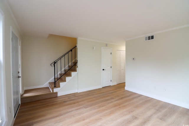 spare room with light hardwood / wood-style flooring and ornamental molding