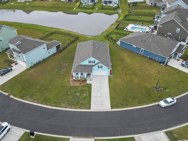 drone / aerial view featuring a water view and a residential view
