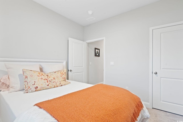 bedroom featuring light carpet