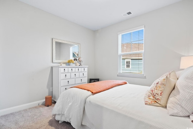 bedroom featuring visible vents, baseboards, and carpet floors