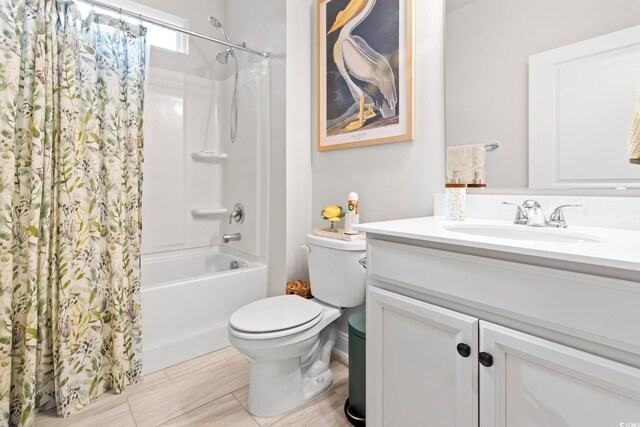 bathroom with toilet, vanity, and shower / bath combo with shower curtain