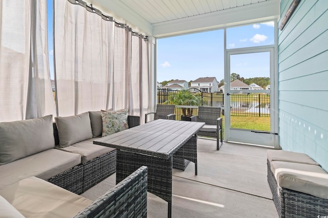 sunroom / solarium featuring a water view