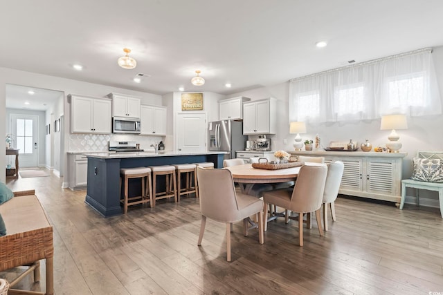 dining area featuring recessed lighting, wood-type flooring, and visible vents