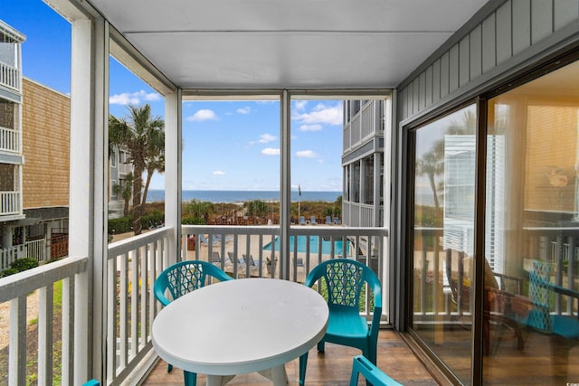 sunroom / solarium with a water view