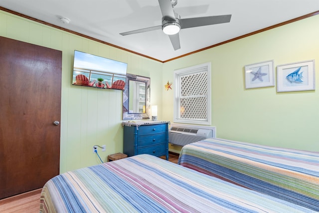 bedroom with ceiling fan, light wood-type flooring, a wall mounted air conditioner, and ornamental molding