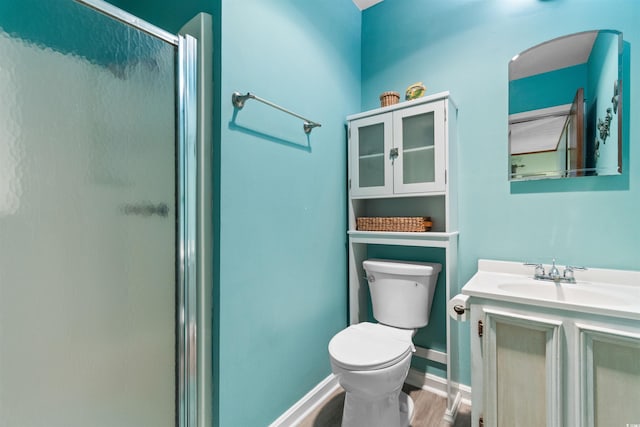 bathroom featuring hardwood / wood-style floors, vanity, toilet, and walk in shower