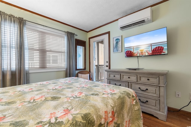 bedroom featuring hardwood / wood-style flooring, a textured ceiling, crown molding, and a wall mounted AC