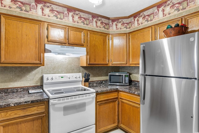 kitchen featuring dark stone countertops, crown molding, and appliances with stainless steel finishes