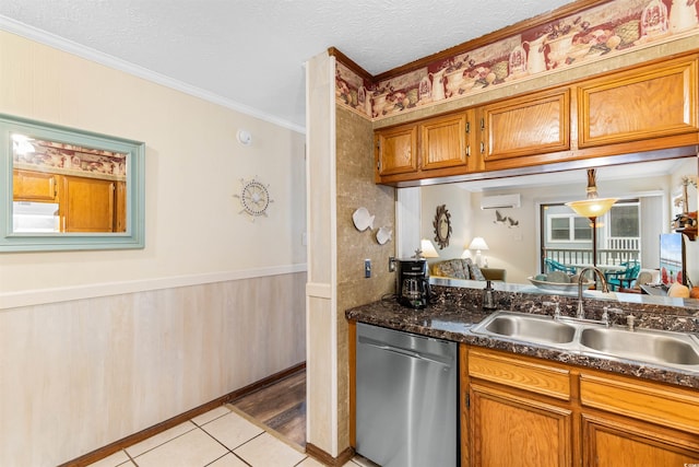 kitchen with sink, stainless steel dishwasher, a wall unit AC, light tile patterned floors, and ornamental molding