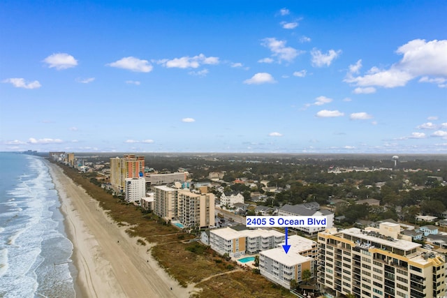 drone / aerial view with a water view and a view of the beach