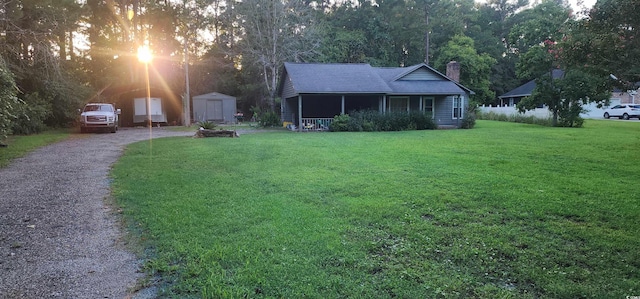 view of yard with a shed and covered porch