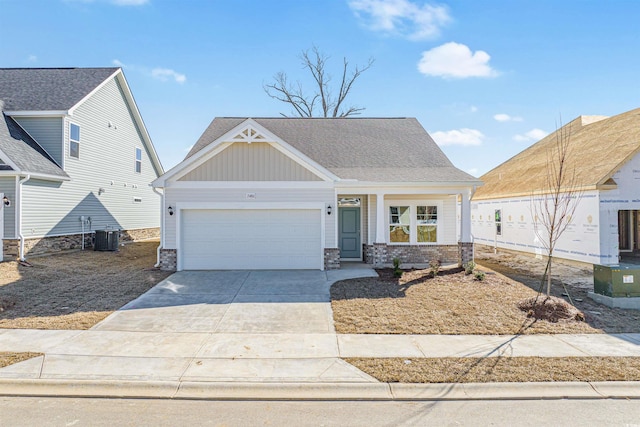 view of front of property with central AC unit, an attached garage, brick siding, driveway, and board and batten siding