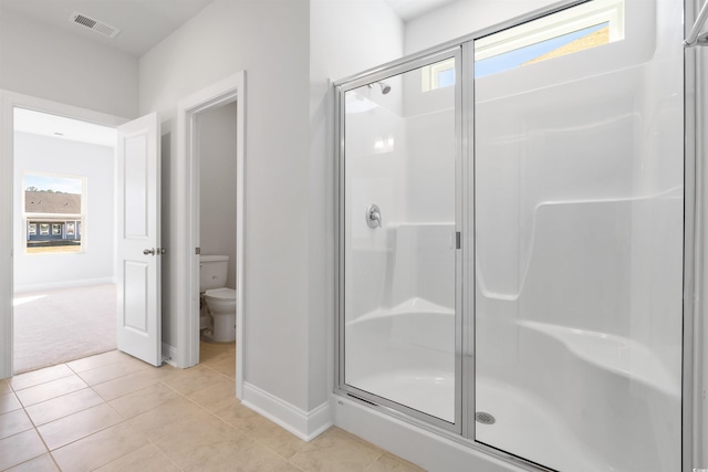 full bath with visible vents, tile patterned flooring, a shower stall, and toilet