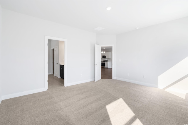 unfurnished bedroom featuring recessed lighting, light carpet, and baseboards