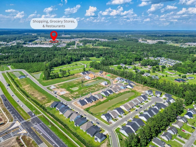 birds eye view of property with a wooded view and a residential view