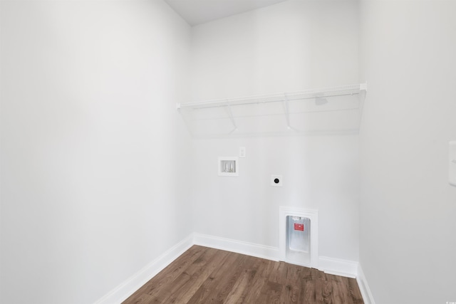 laundry room featuring washer hookup, dark wood finished floors, electric dryer hookup, laundry area, and baseboards