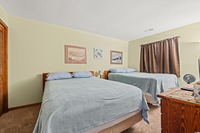 bedroom with a closet and light carpet