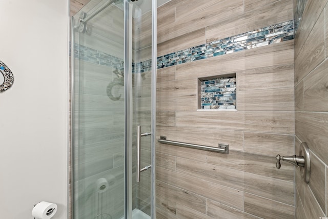 bathroom with a shower with shower door