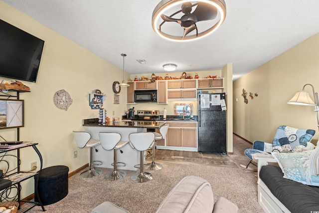 living room featuring light carpet, sink, and a textured ceiling