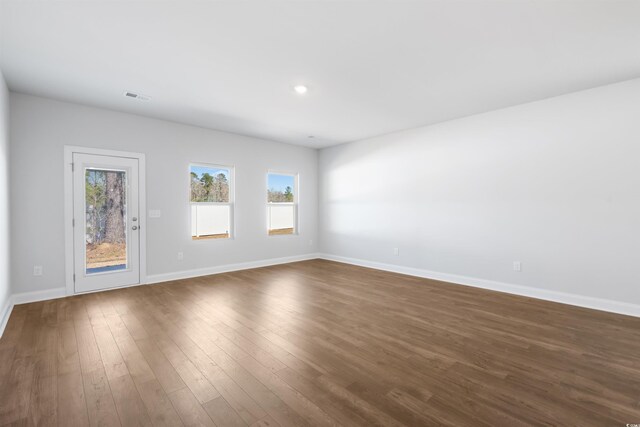 unfurnished living room with a chandelier and wood-type flooring