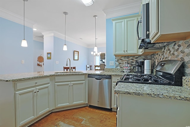 kitchen featuring light stone countertops, appliances with stainless steel finishes, pendant lighting, and sink