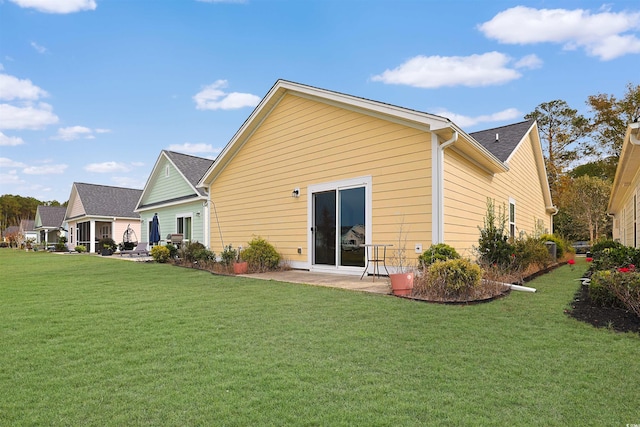 rear view of property with a lawn